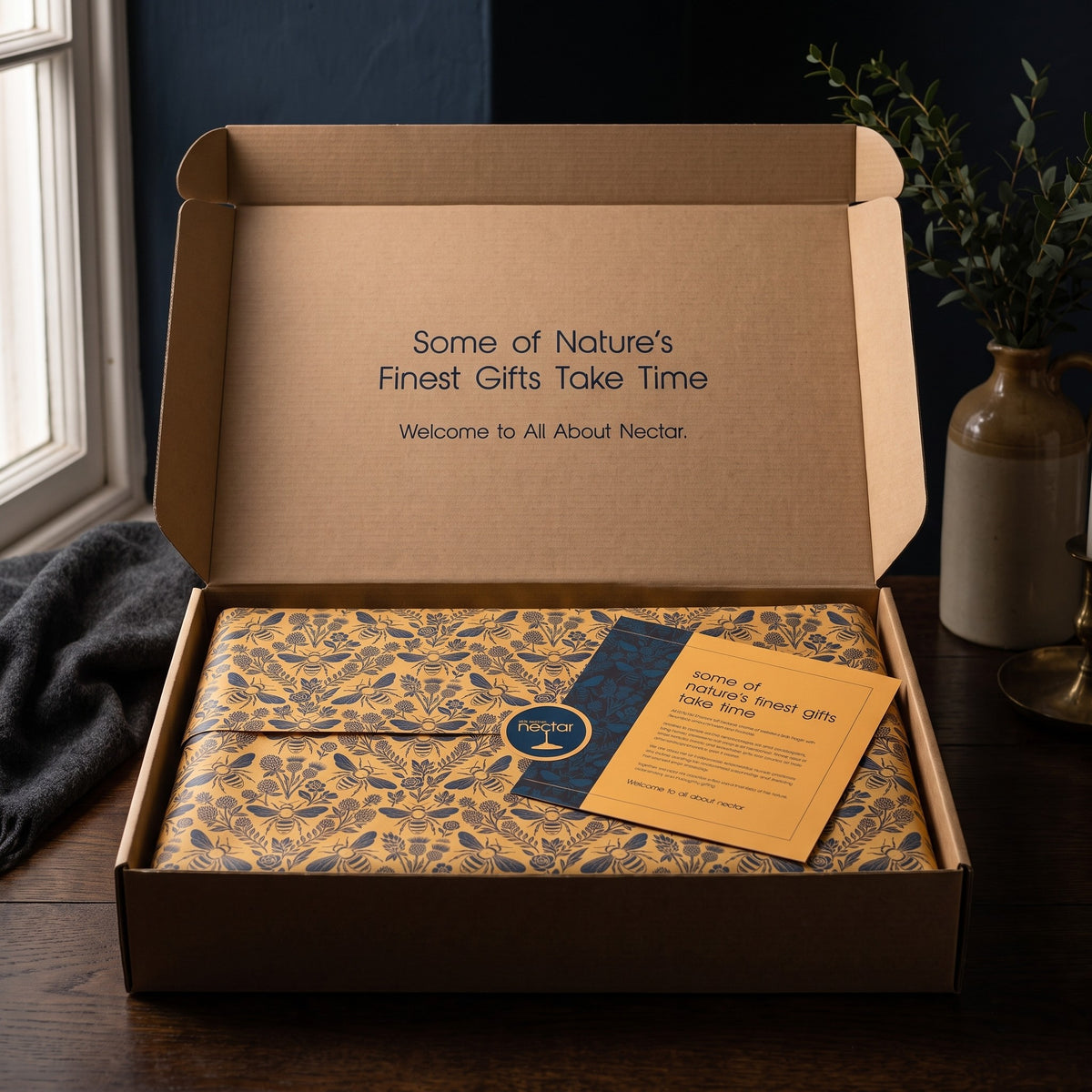 The Grand hamper opened, gold tissue sealed with a story card on top